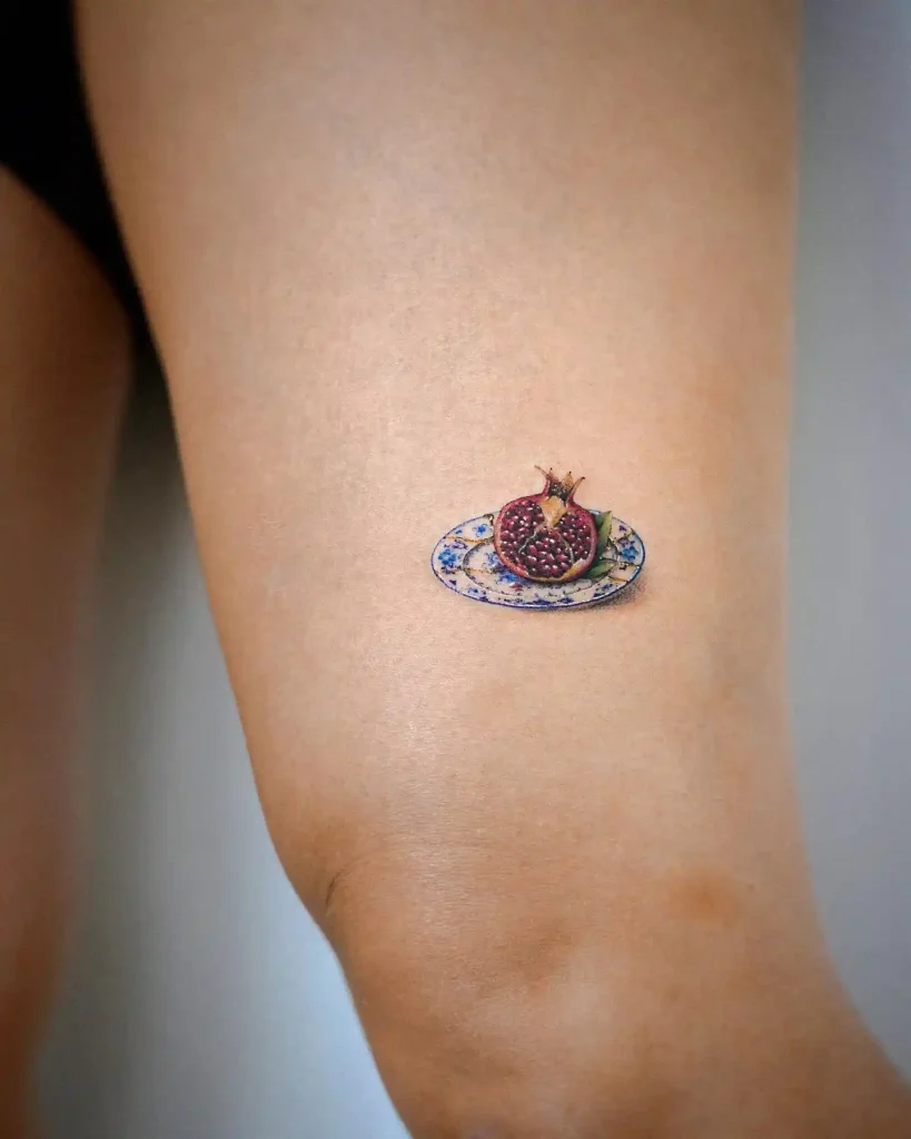 Realistic Pomegranate on Decorative Plate on Thigh