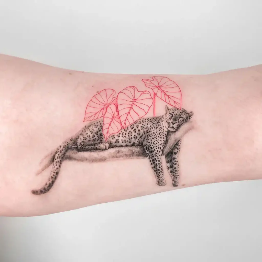Resting Jaguar with Red Leaves on Forearm