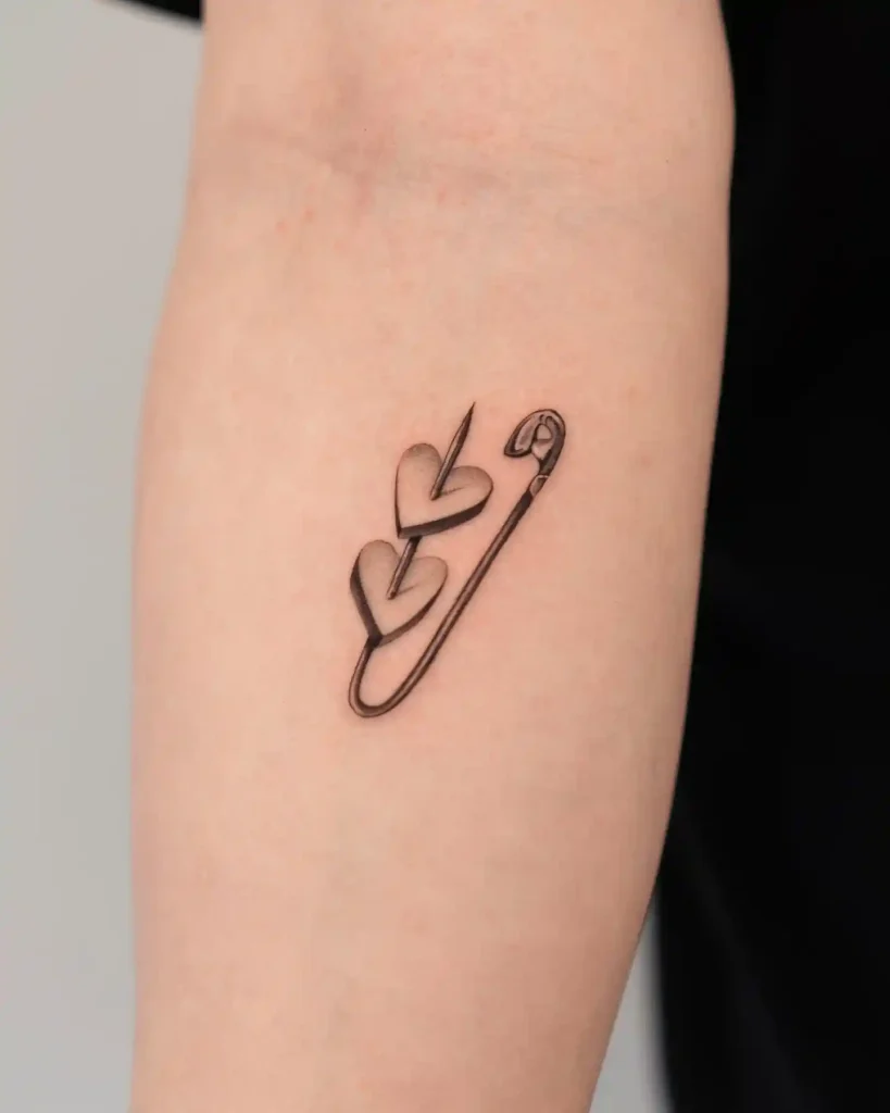 Safety Pin with Hearts Tattoo on Inner Forearm