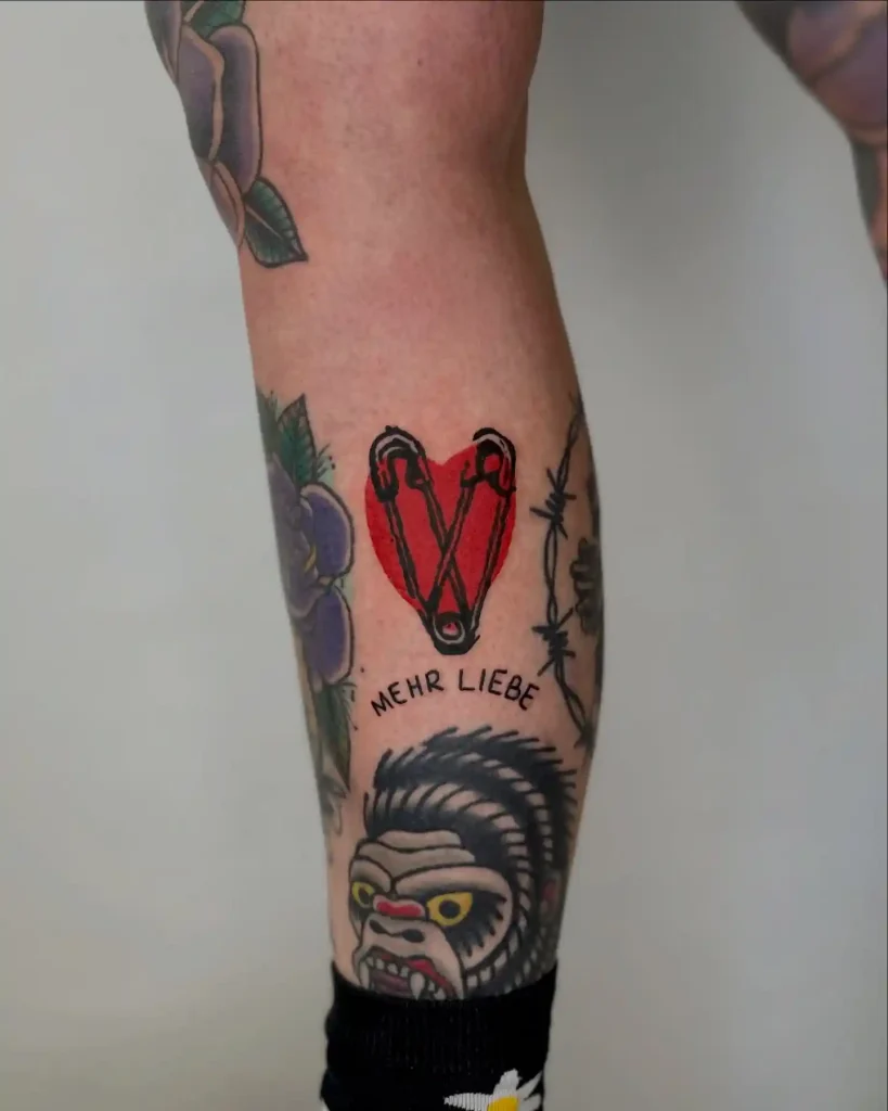 Safety Pins and Red Heart on Lower Leg