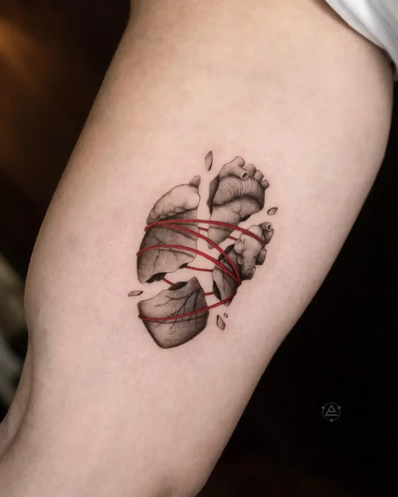Shattered Heart Bound with Red Thread on Inner Arm