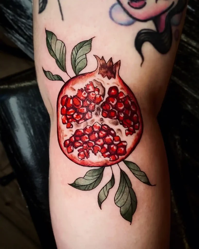 Sliced Pomegranate with Green Leaves on Inner Arm