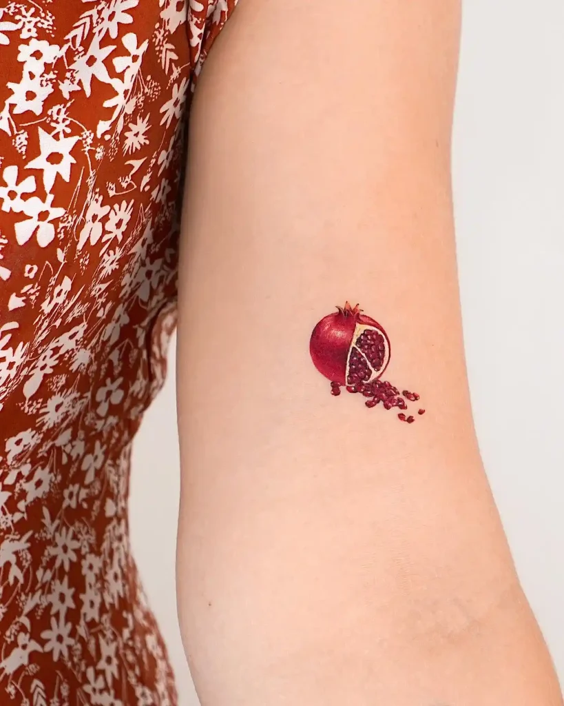 Small Pomegranate with Spilled Seeds on Inner Arm