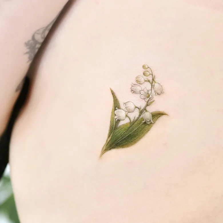 Soft Realistic Lily of the Valley Rib Tattoo