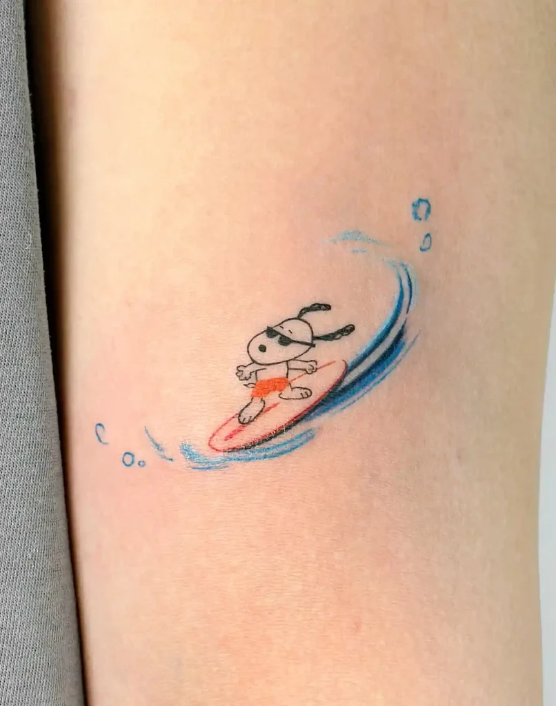 Surfing Snoopy Tattoo on Inner Arm