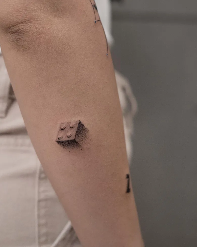 Tiny Floating Brick Lego Tattoo