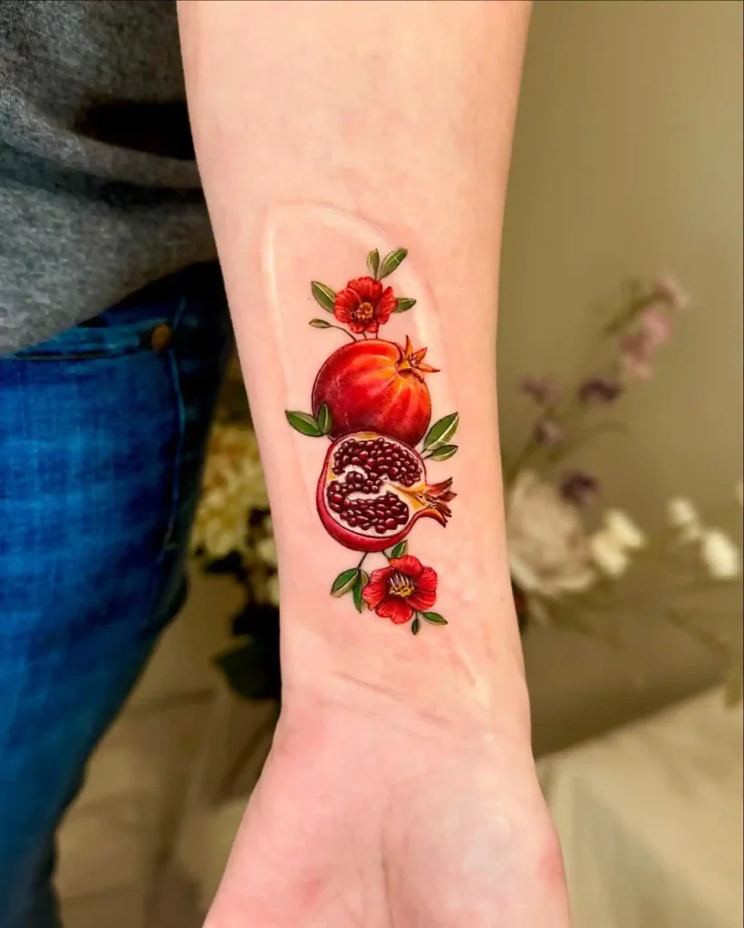 Vibrant Pomegranate and Flower Illustration on Forearm