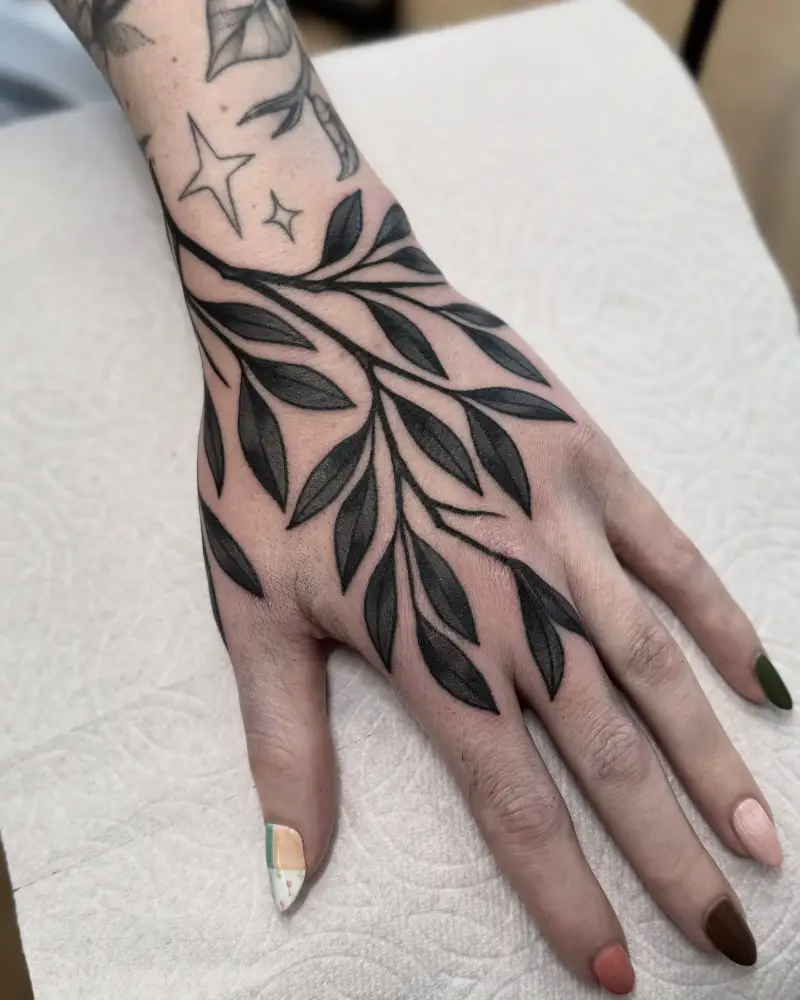 Bold Blackwork Botanical Hand Tattoo