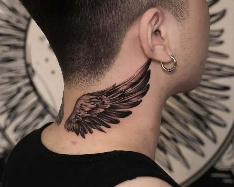 Bold Realistic Wing Neck Tattoo