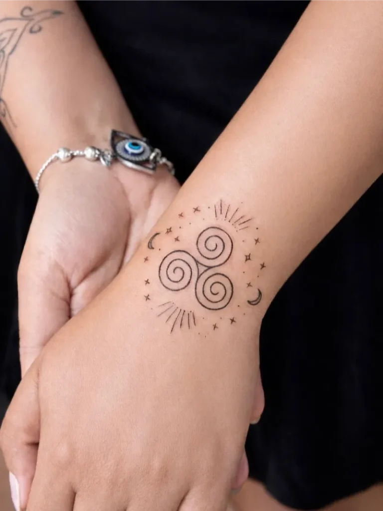 Celestial Triskele Wrist Tattoo