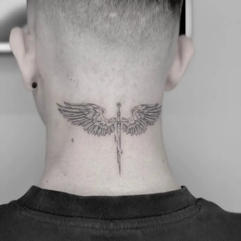 Delicate Fine Line Winged Sword Tattoo