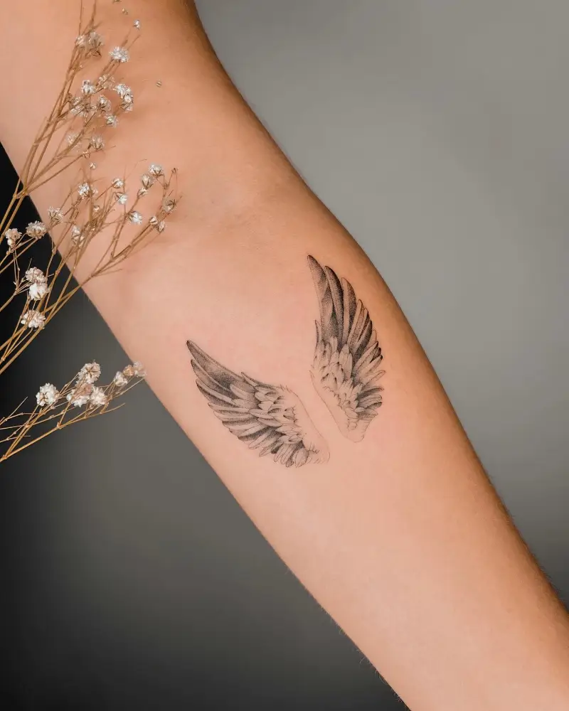 Delicate Forearm Angel Wings Tattoo