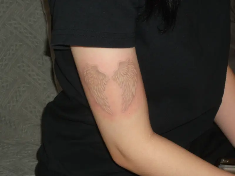 Ethereal White Ink Angel Wings Tattoo