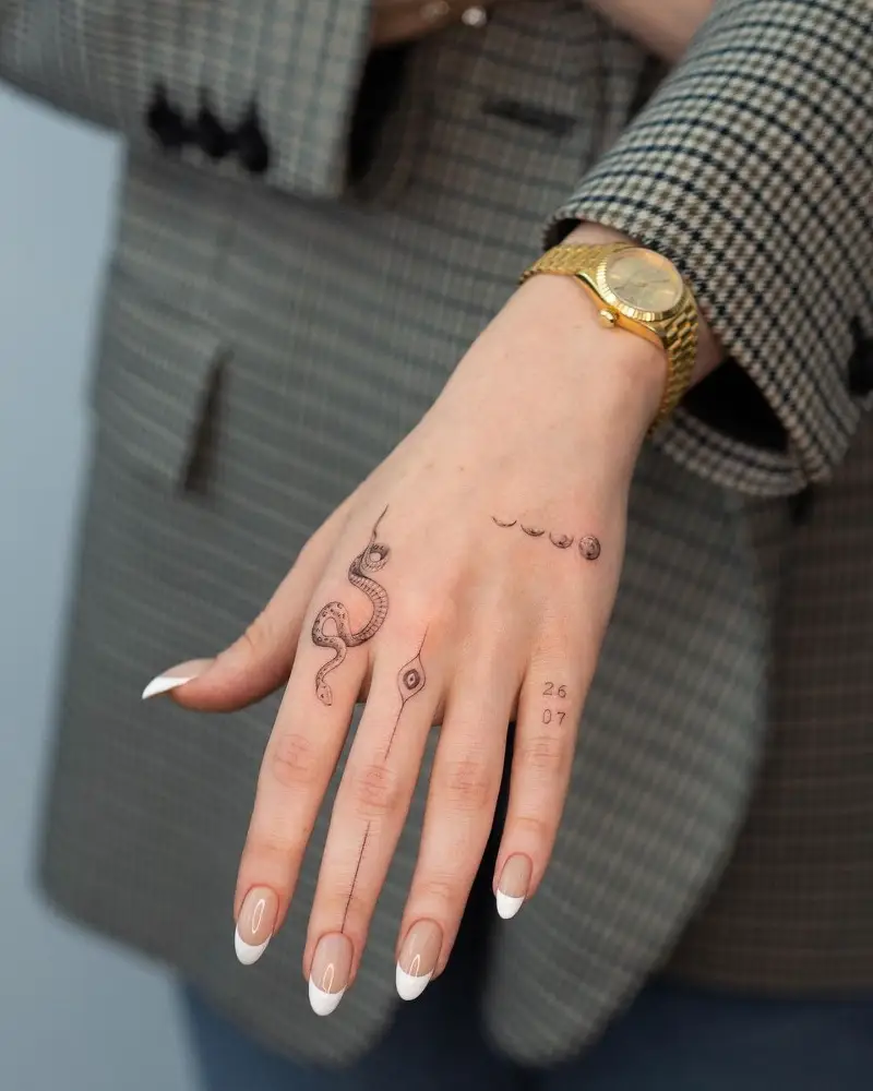 Fine Line Symbolic Hand Tattoo