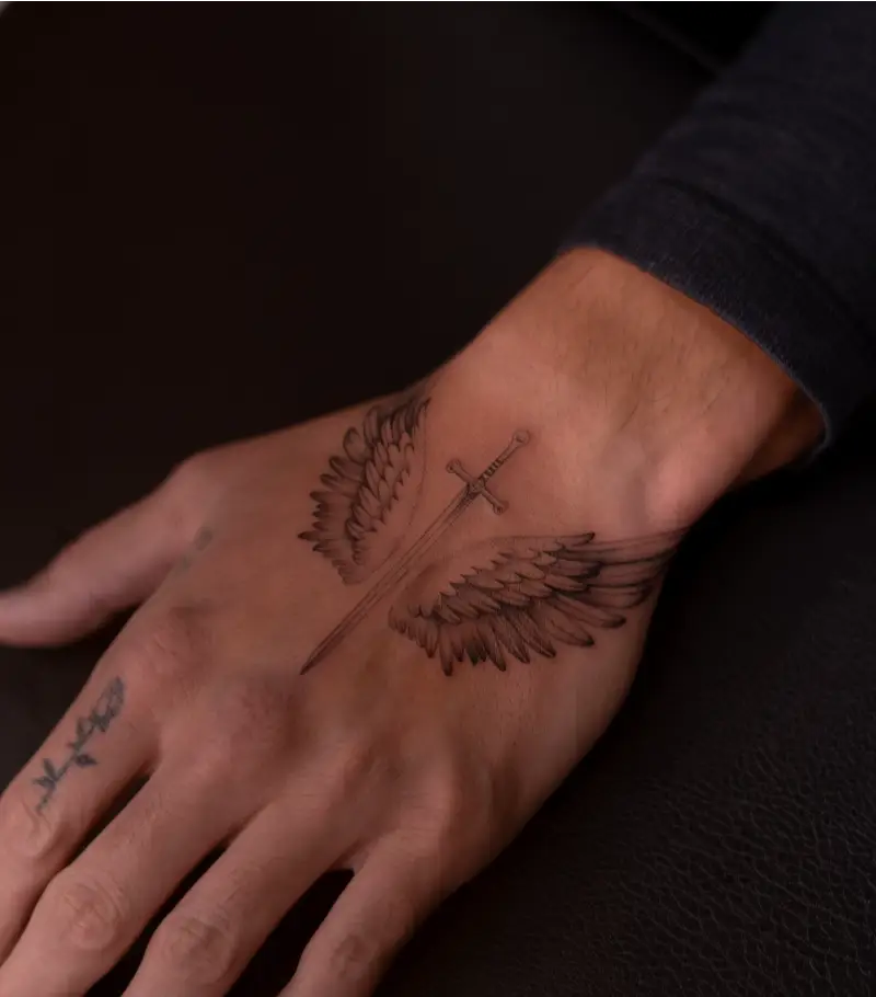 Fine Line Winged Sword Hand Tattoo