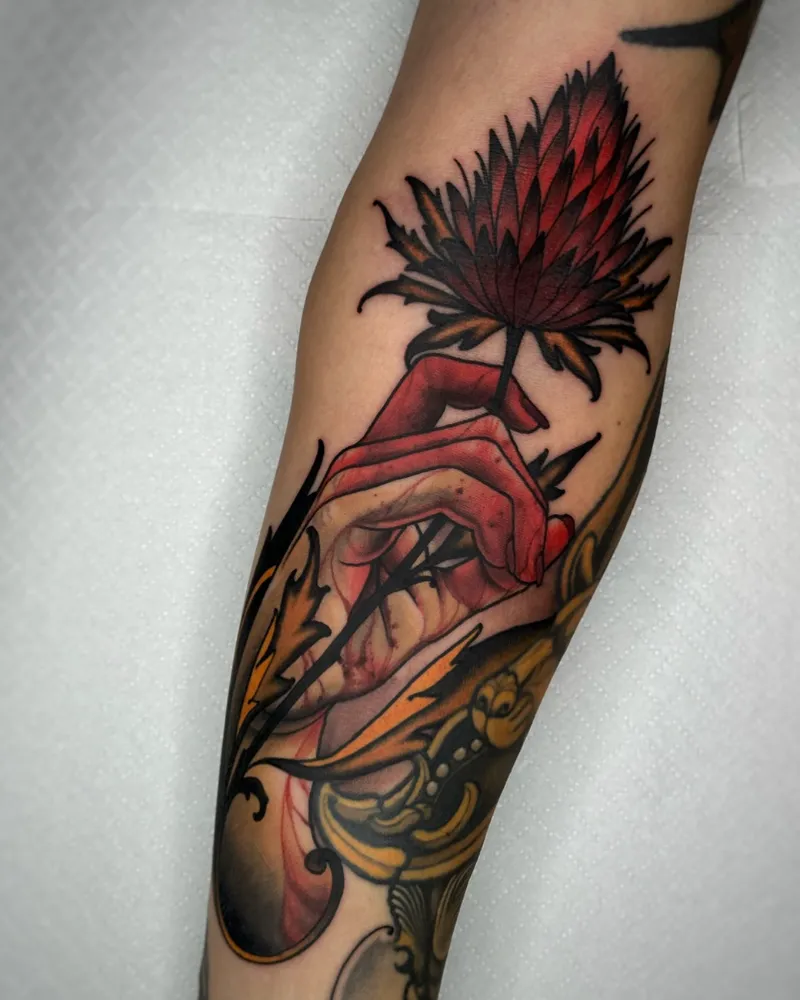 Illustrative Thistle Flower Tattoo With Hand