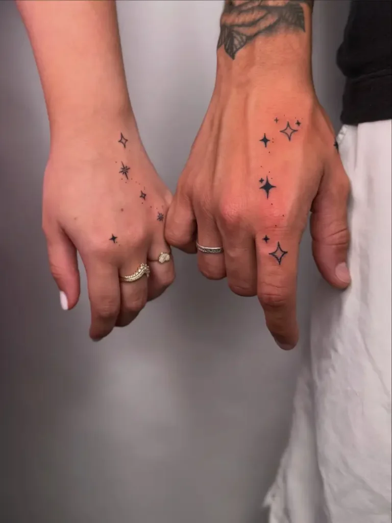 Matching Fine Line Celestial Hand Holding Tattoo