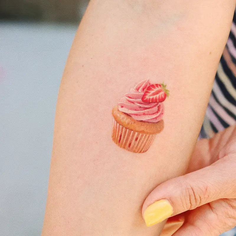 Micro Realistic Strawberry Cupcake Tattoo