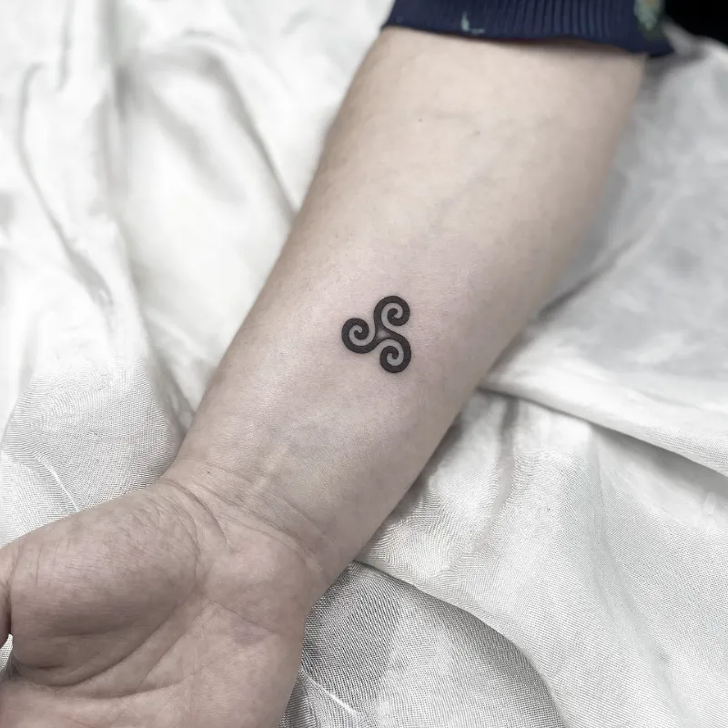 Minimal Blackwork Triskele Tattoo