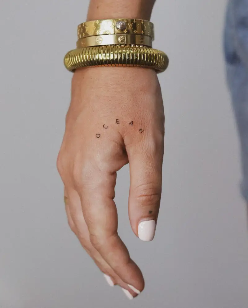 Minimalist Arc Lettering Hand Tattoo
