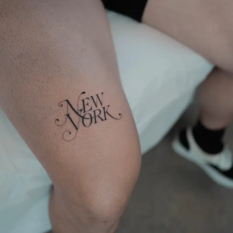Ornamental New York Lettering Tattoo