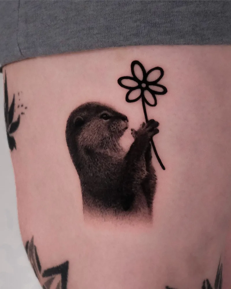Realistic Flower Holding Otter Tattoo