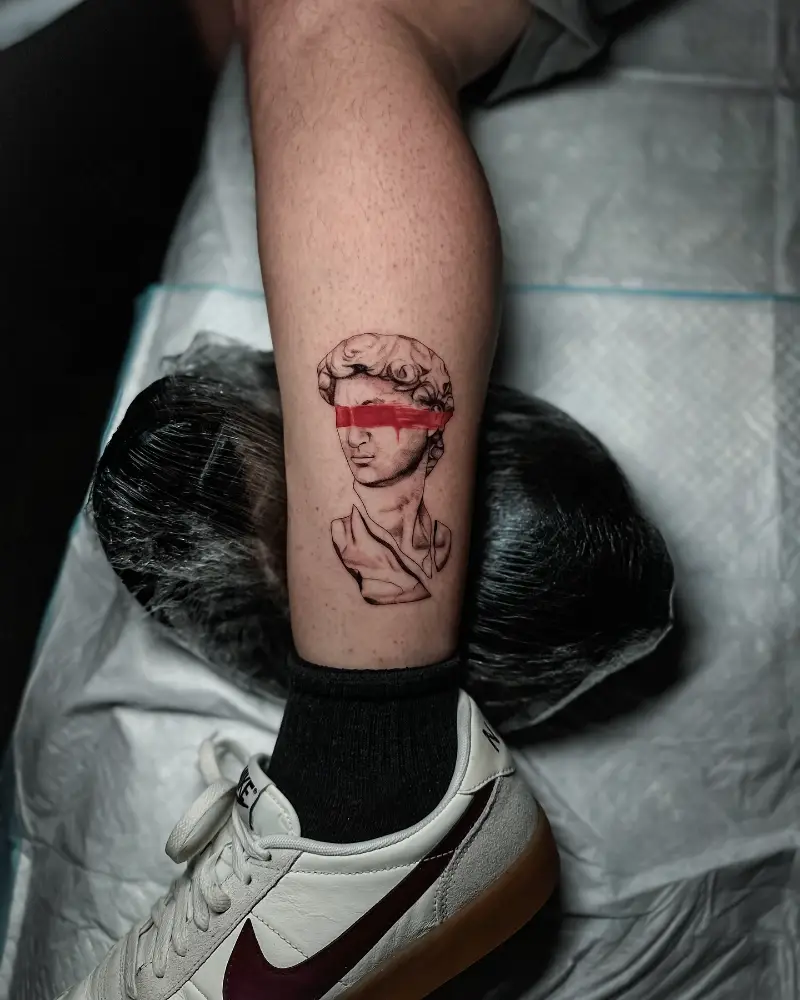 Red Blindfold Greek God Tattoo
