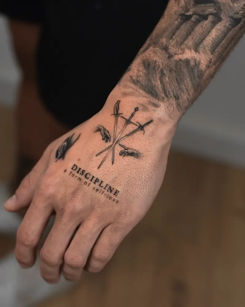 Symbolic Fine Line Sword Hand Tattoo