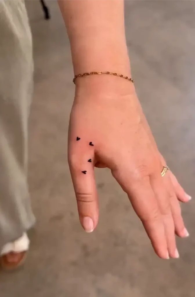 Thumb Hold Heart Tattoo