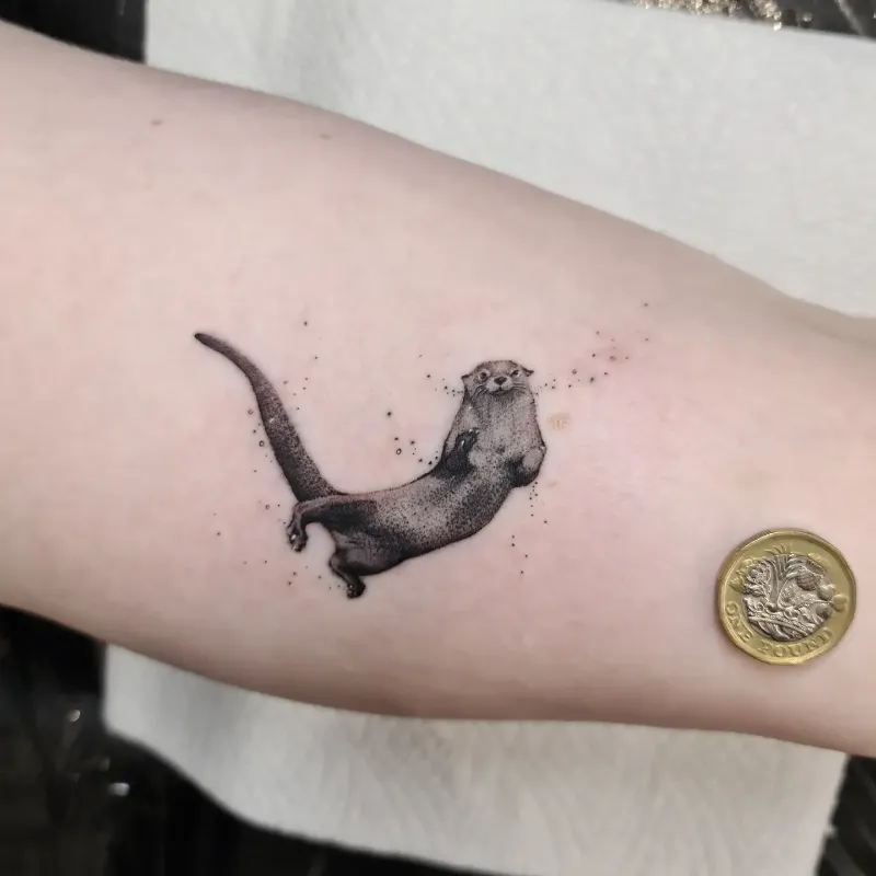 Tiny Floating Dotwork Otter Tattoo