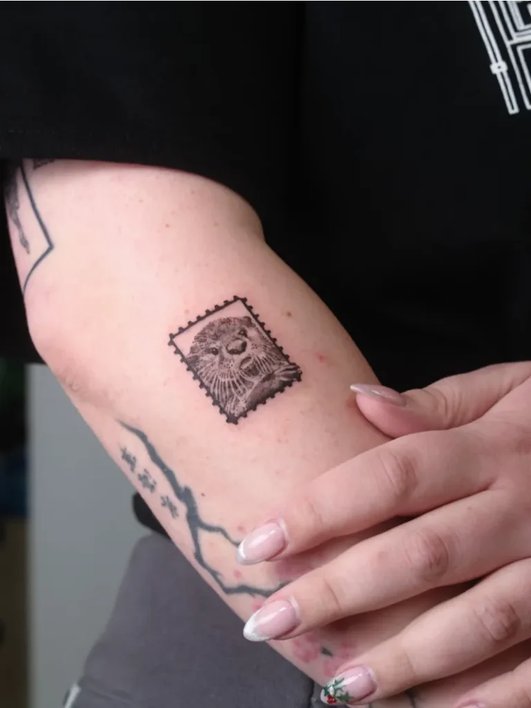 Tiny Postage Stamp Otter Tattoo