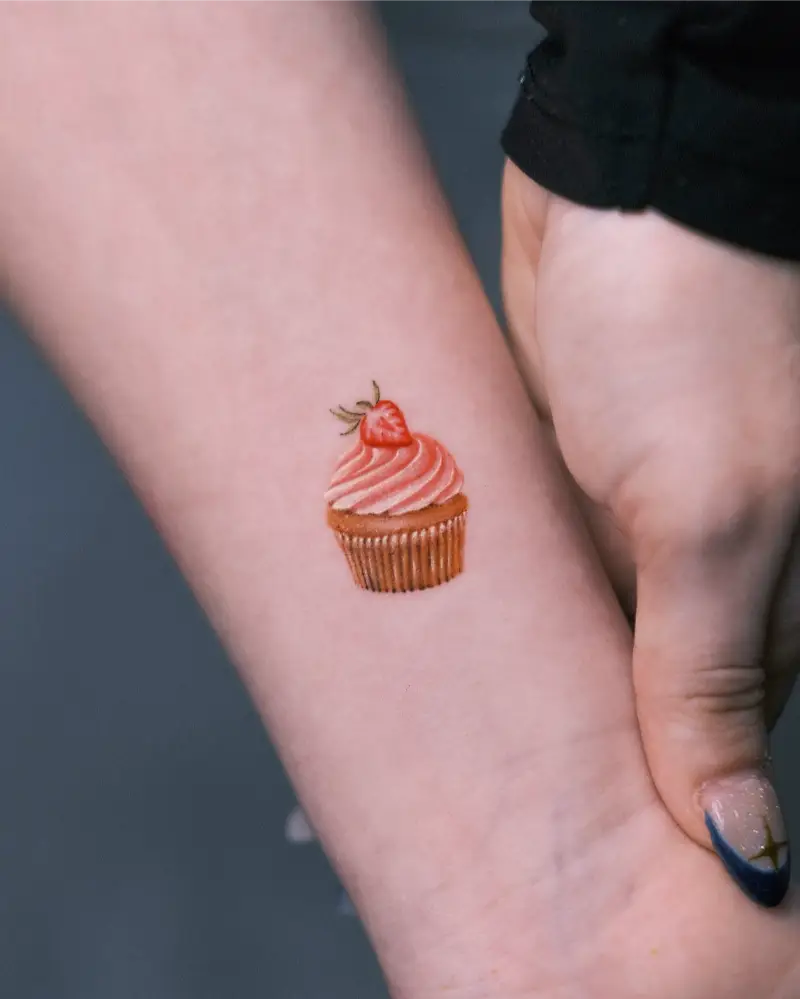 Tiny Realistic Strawberry Cupcake Tattoo