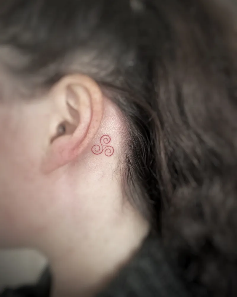 Tiny Red Triskele Ear Tattoo