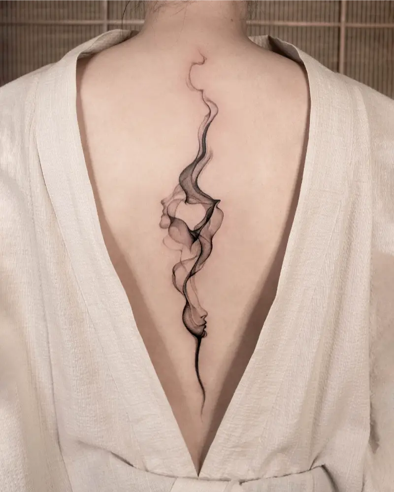 Abstract Surreal Face Spine Tattoo