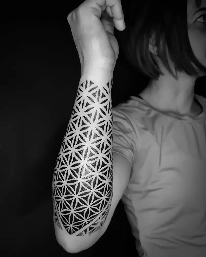 Bold Negative Space Flower of Life Forearm Tattoo