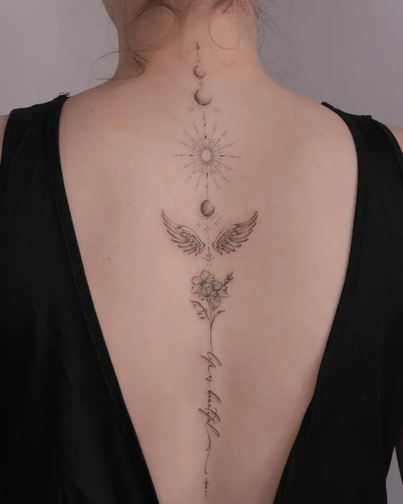Celestial Wings and Floral Spine Tattoo