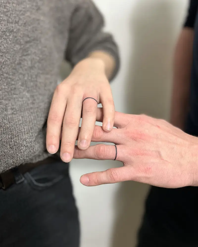 Delicate Fine Line Wedding Ring Tattoo