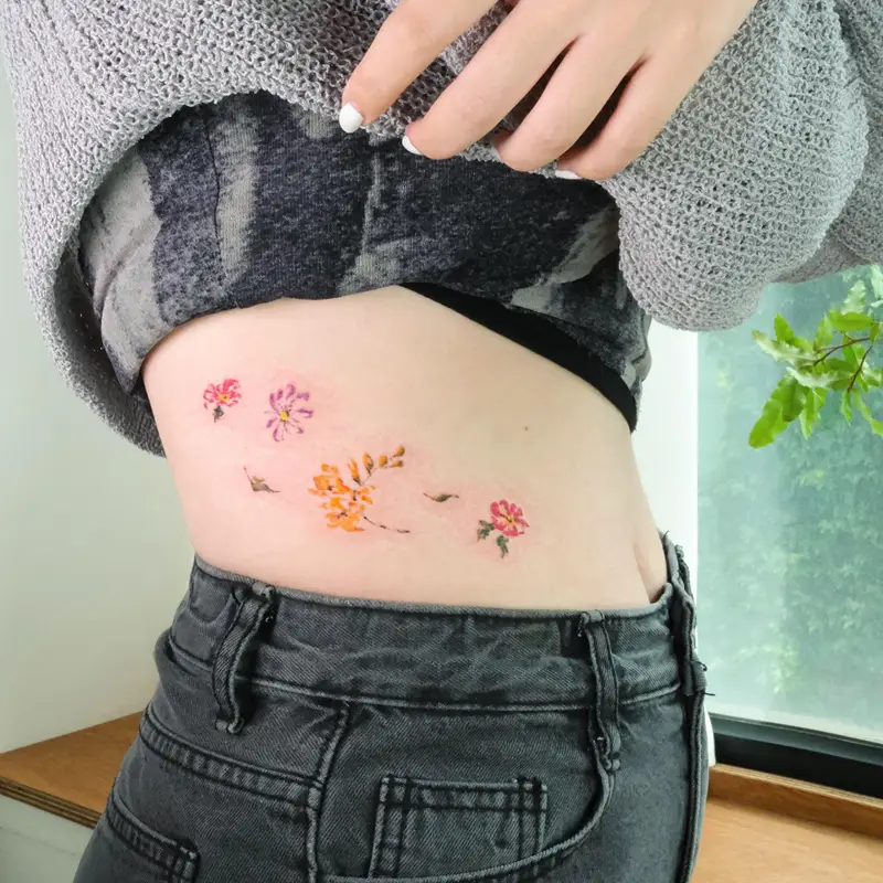 Delicate Watercolor Wildflower Belly Tattoo