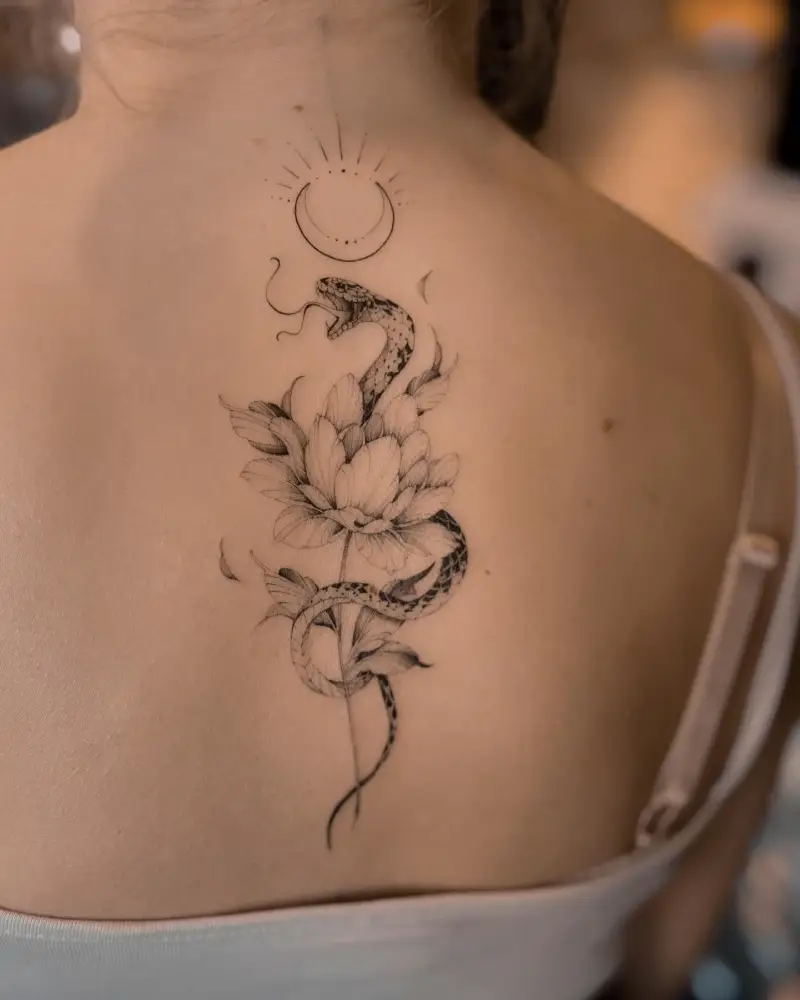Fine Line Snake and Lotus Spine Tattoo