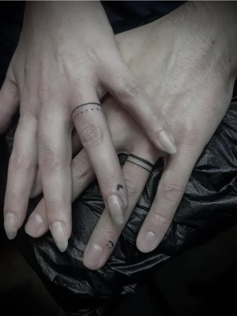 Fine Line Wedding Ring Tattoo with Personal Symbols
