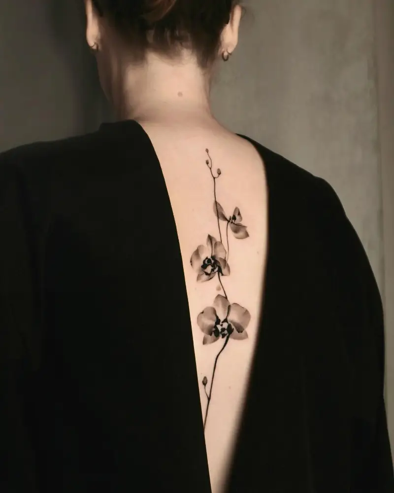 Minimalist Orchid Spine Tattoo