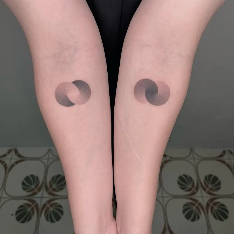Minimalist Overlapping Circle Pair Tattoo