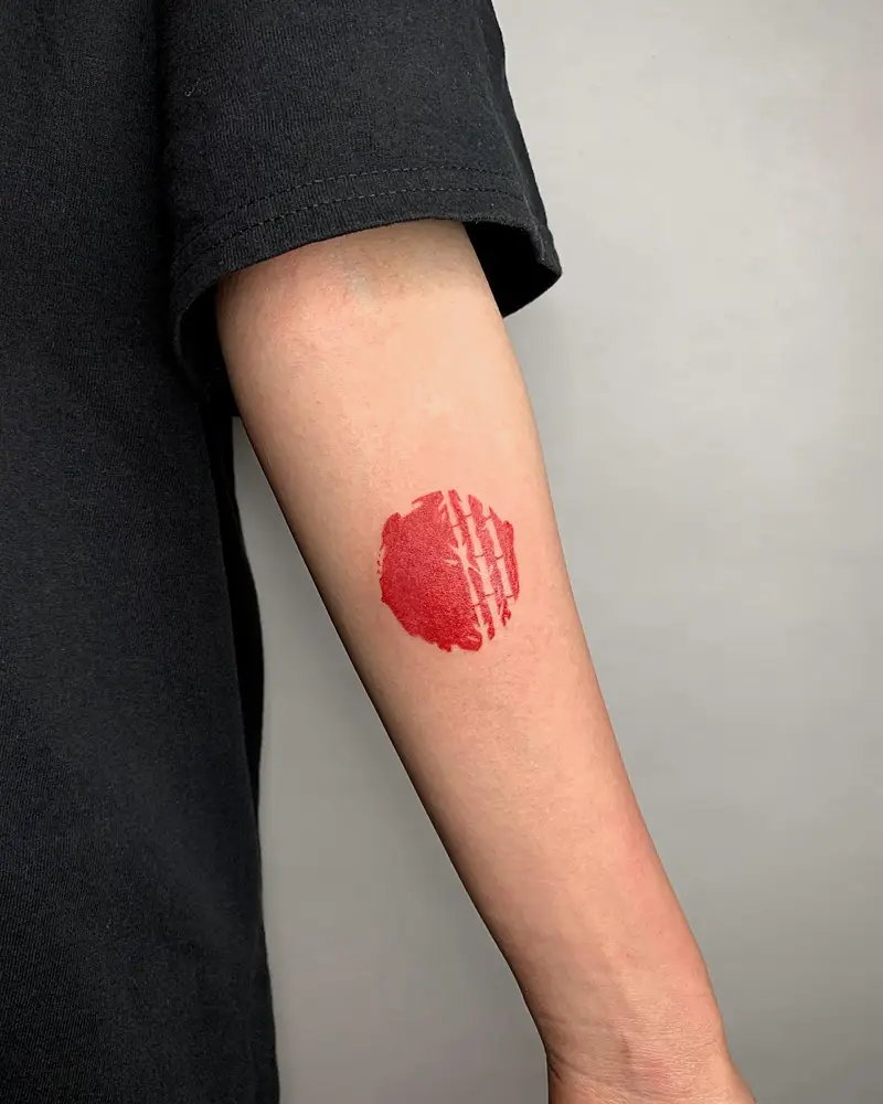 Minimalist Red Brushstroke Circle Tattoo