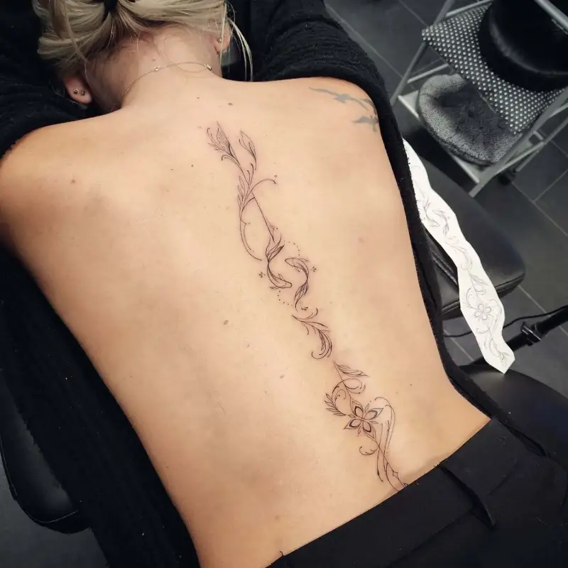 Ornamental Floral Vine & Koi Fish Spine Tattoo
