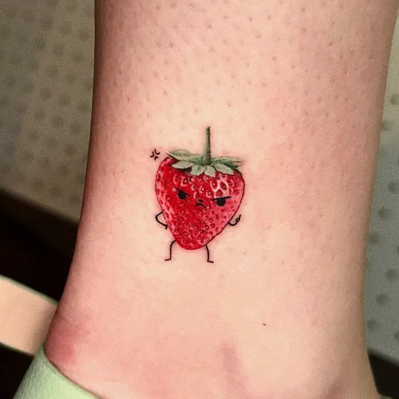 Playful Angry Strawberry Character Tattoo