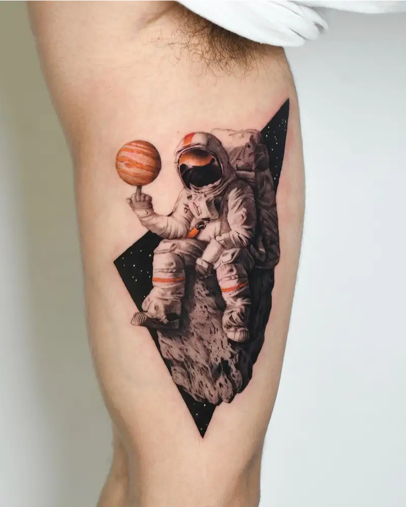 Realistic Astronaut Holding Spinning Jupiter Tattoo