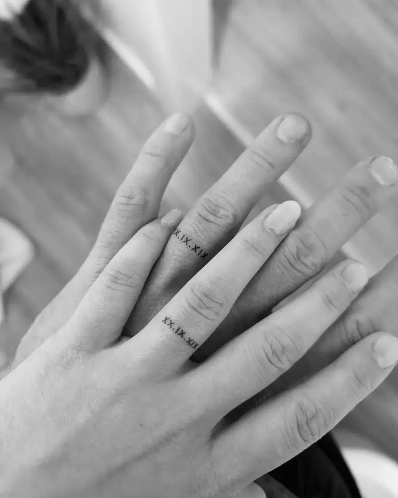 Roman Numeral Matching Wedding Ring Tattoo