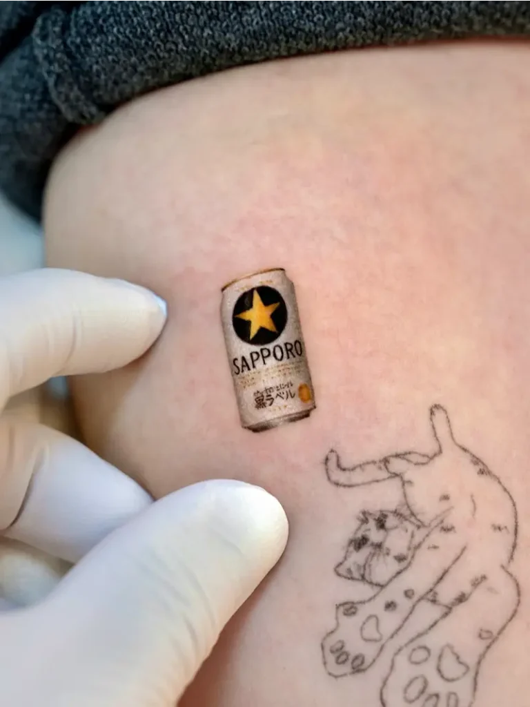 Tiny Sapporo Beer Can Tattoo