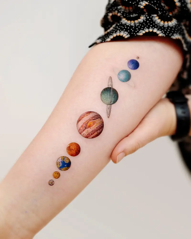 Vertical Colorful Planet Forearm Tattoo