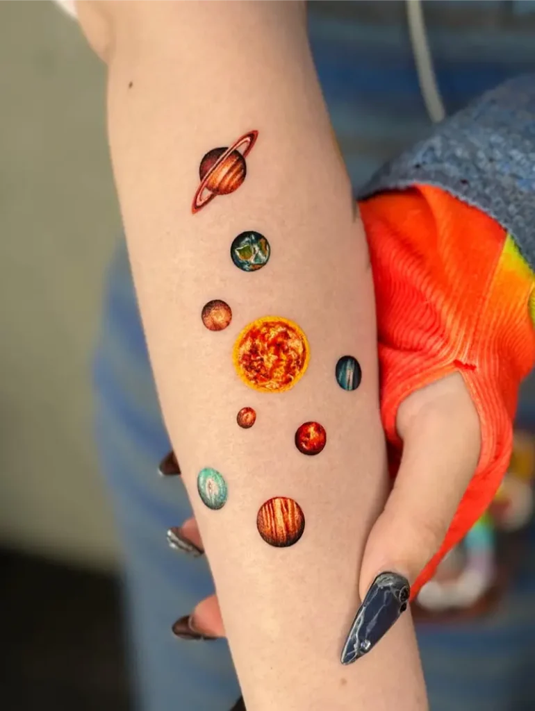 Vibrant Solar System Planet Forearm Tattoo